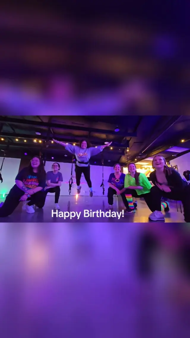 A birthday group at a Boujee Bungee event - one guest airborne with arms and legs spread wide while the rest cheer from their harnesses
